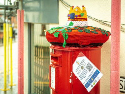 Postbox with a crocheted crown on the top for Charity Christmas campaign