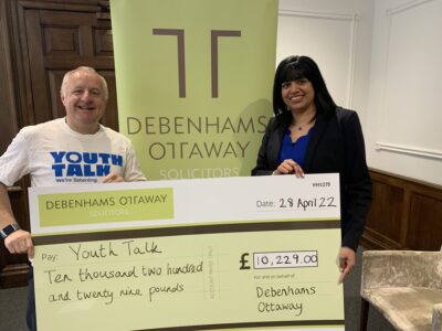 CEO of Youth Talk holds a supersized cheque from Debenhams Ottaway