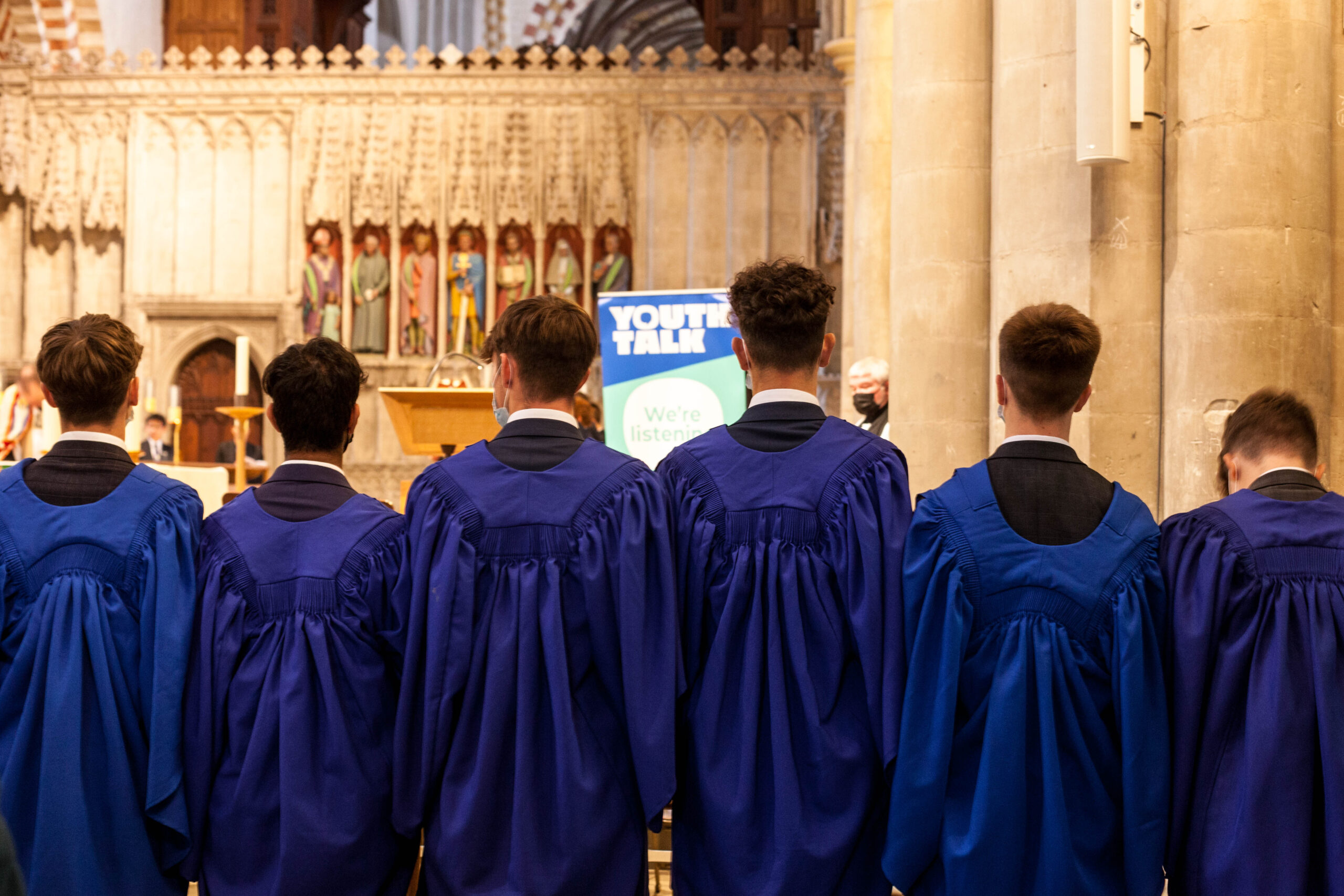 A group of Verulam School students standing in St Albans Cathedral in blue gowns
