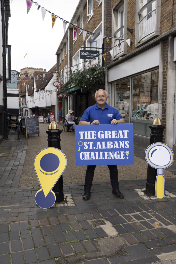 David Barker, CEO of Youth Talk, holding a sign that says 'The Great St Albans Challenge'